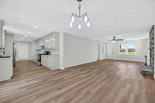 a view of a kitchen with wooden floor and a kitchen
