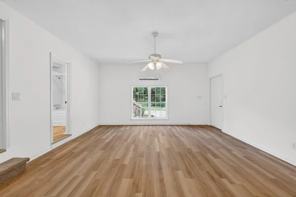 wooden floor in an empty room with a window