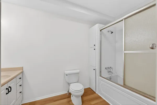 a bathroom with a granite countertop toilet and a sink
