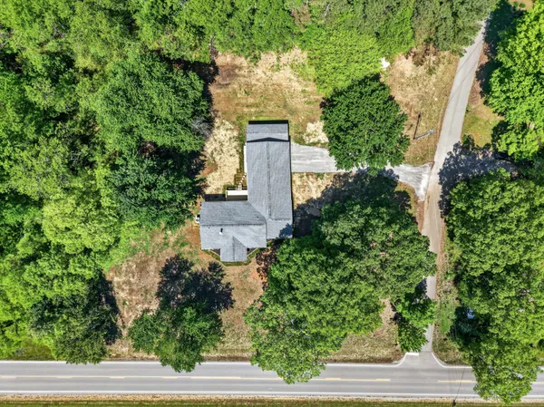 an aerial view of a house with outdoor space and street view