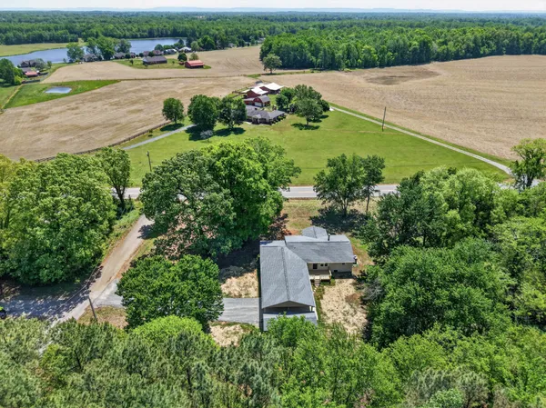 an aerial view of lake residential house with outdoor space and trees around
