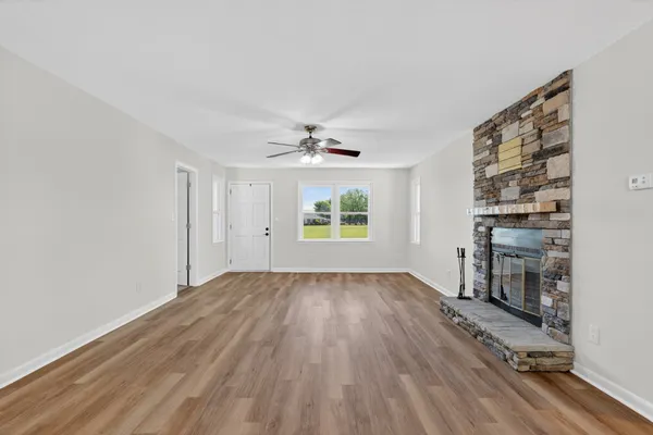 wooden floor in an empty room with a window