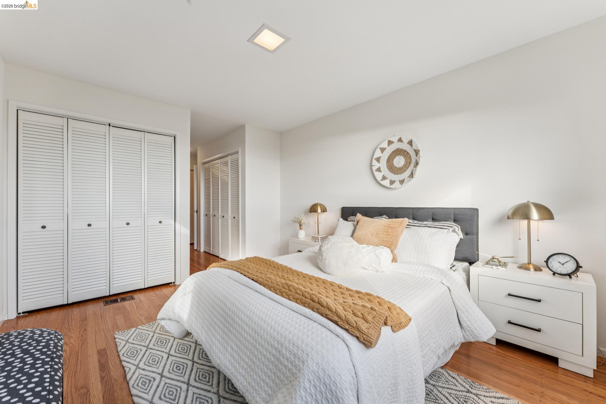 1155 Keeler Avenue Berkeley, CA 94708 - Photo 22 of 45 a bedroom with a bed and a lamp with the wooden floor
