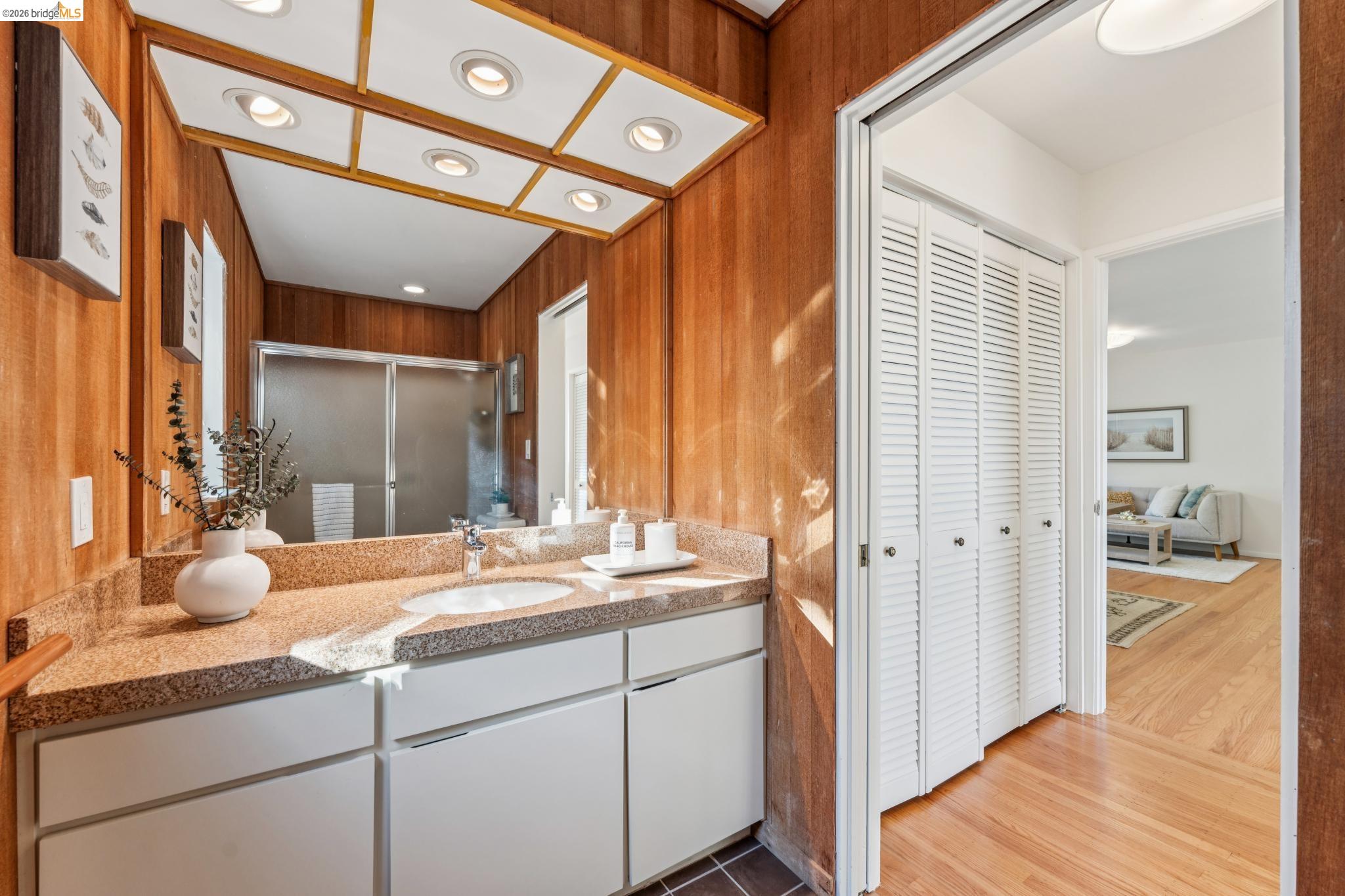 1155 Keeler Avenue Berkeley, CA 94708 - Photo 24 of 45 a bathroom with a granite countertop sink and a mirror