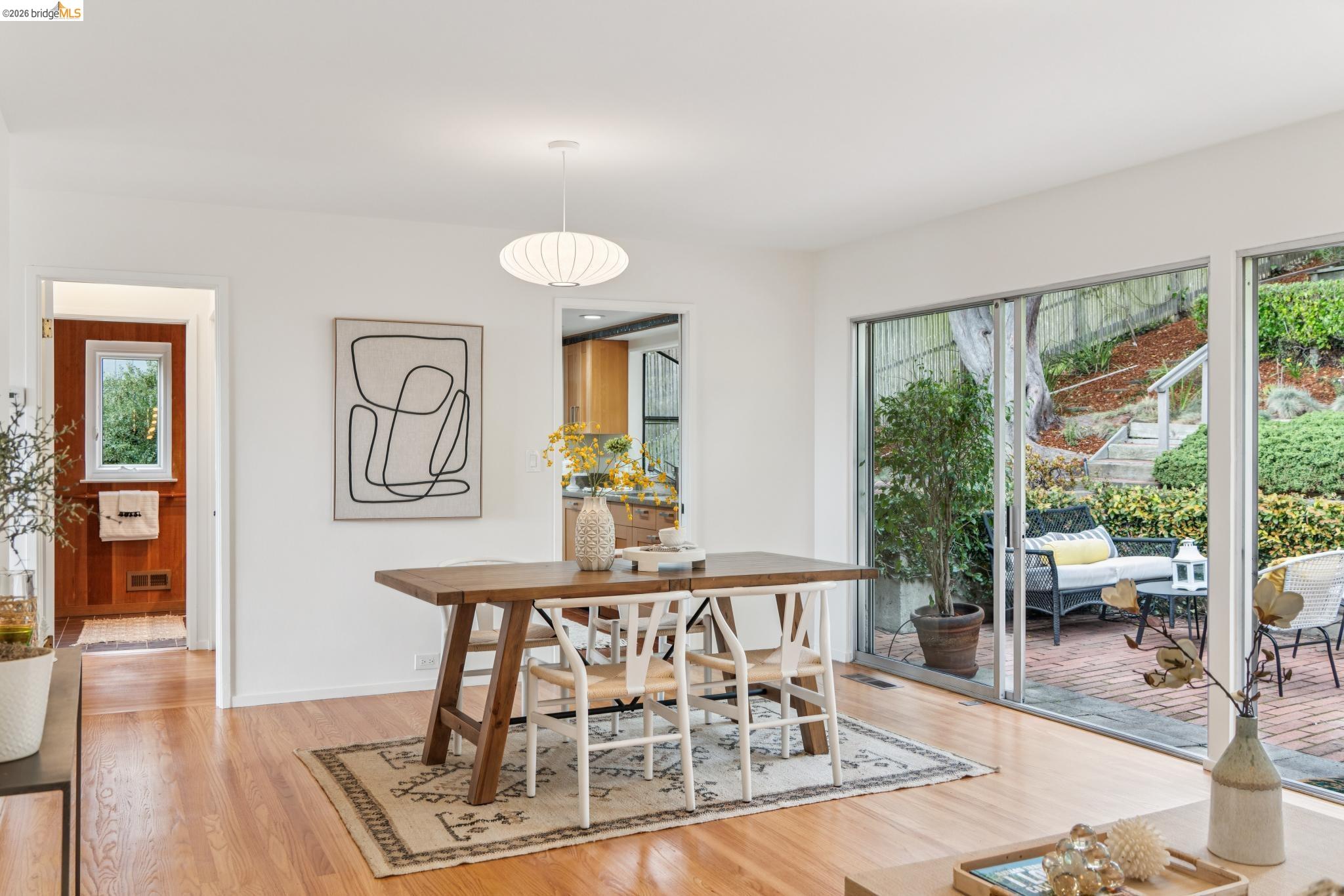 1155 Keeler Avenue Berkeley, CA 94708 - Photo 27 of 45 a dining room with furniture a chandelier and wooden floor