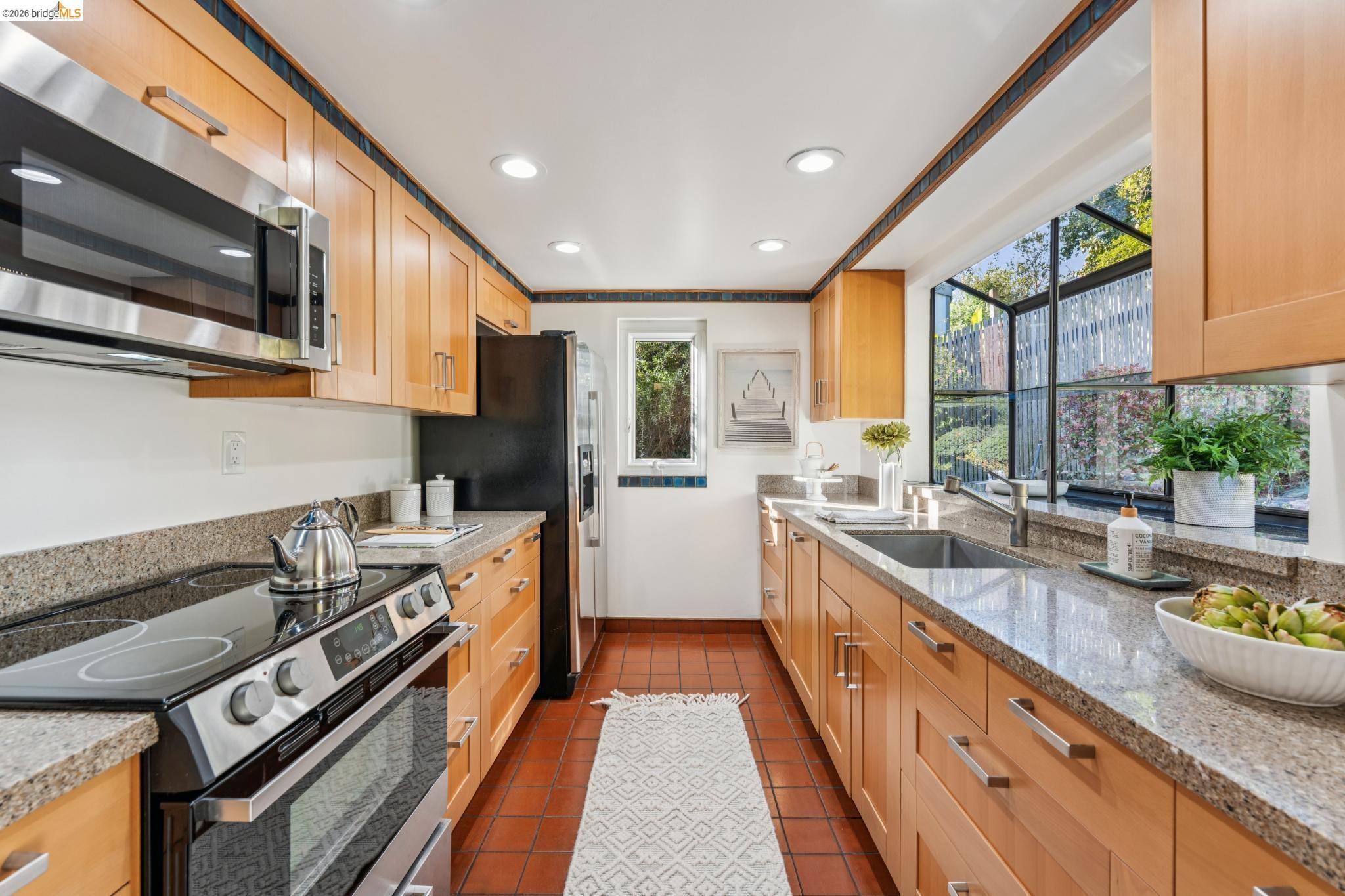 1155 Keeler Avenue Berkeley, CA 94708 - Photo 32 of 45 a kitchen with a stove a sink and a refrigerator