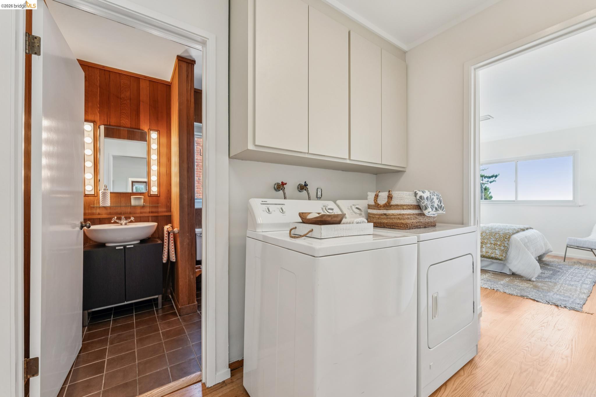 1155 Keeler Avenue Berkeley, CA 94708 - Photo 37 of 45 a utility room with cabinets washer and dryer