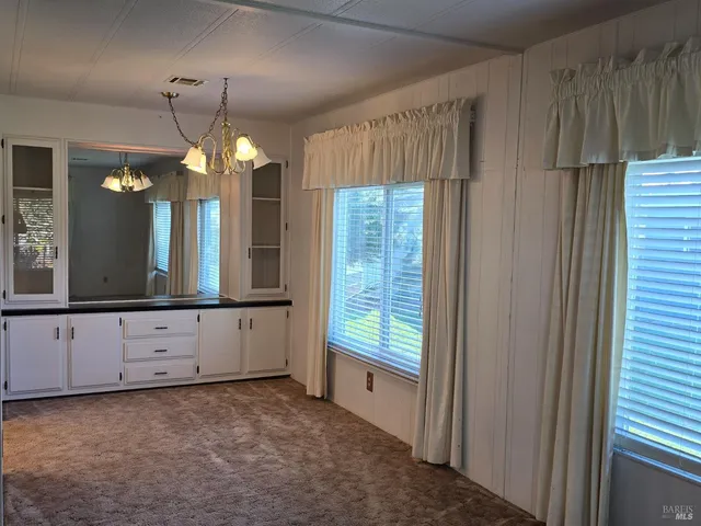 a view of a kitchen with chandelier and window