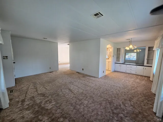 an empty room with windows and entrance