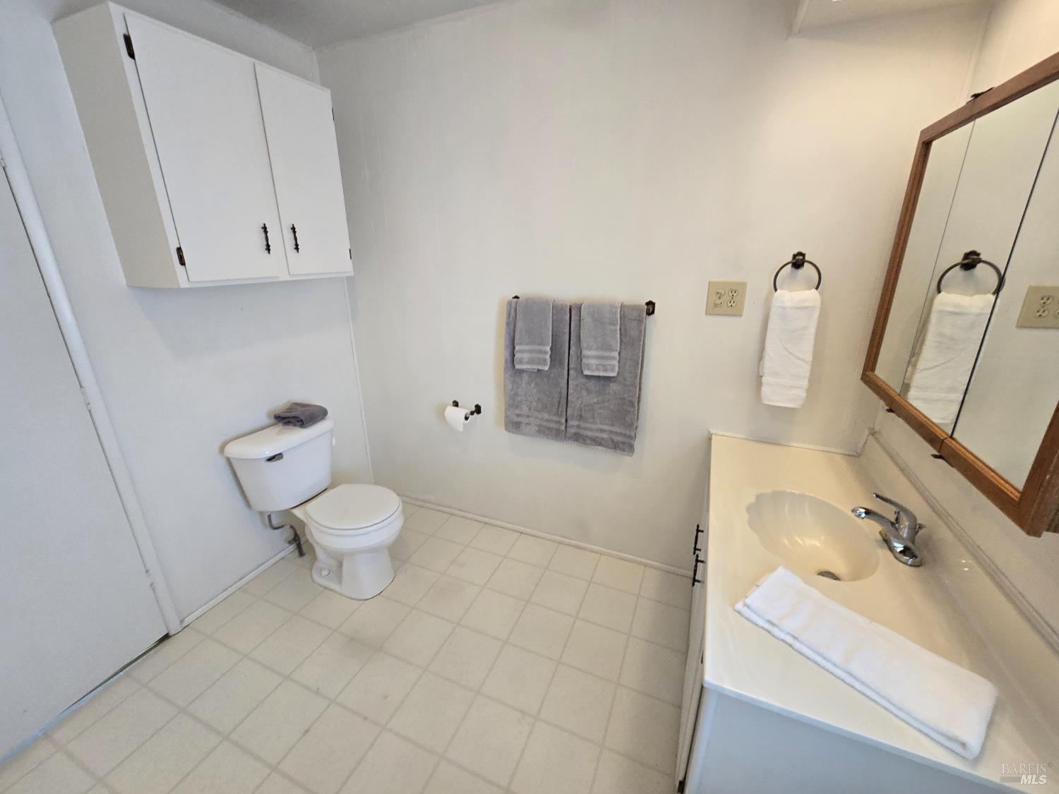 233 Apple Lane Rohnert Park, CA 94928 - Photo 18 of 19 a bathroom with a sink toilet and shower