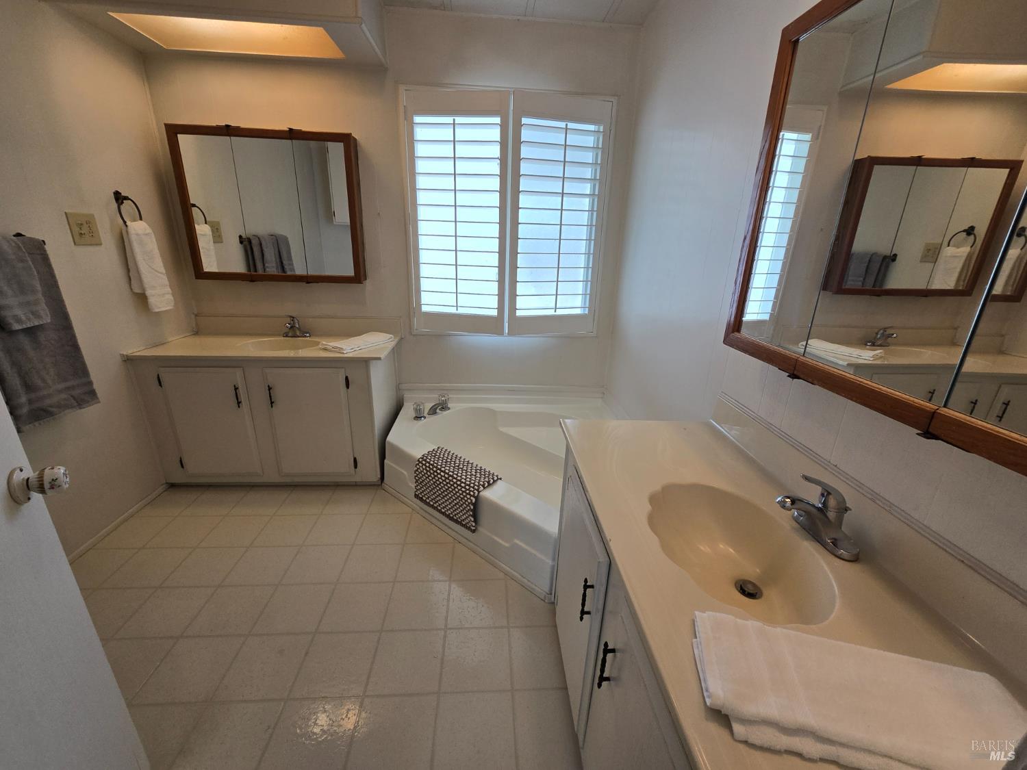 233 Apple Lane Rohnert Park, CA 94928 - Photo 2 of 19 a bathroom with a sink mirror and window