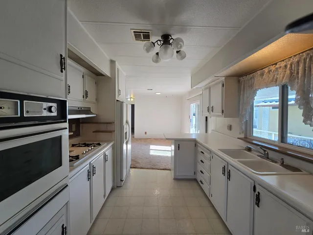 a kitchen with stainless steel appliances granite countertop a sink and stove