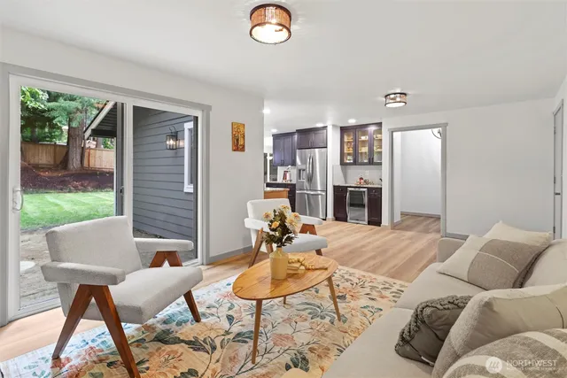 a view of a dining room with furniture a kitchen and chandelier
