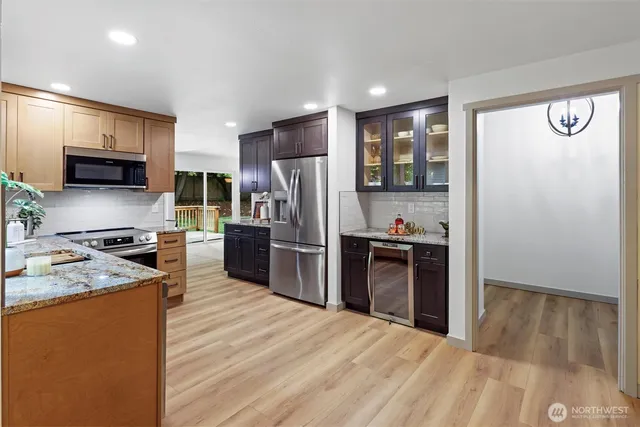 a kitchen with stainless steel appliances granite countertop a refrigerator stove and oven