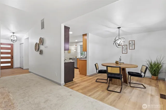 a view of a dining room with furniture and wooden floor