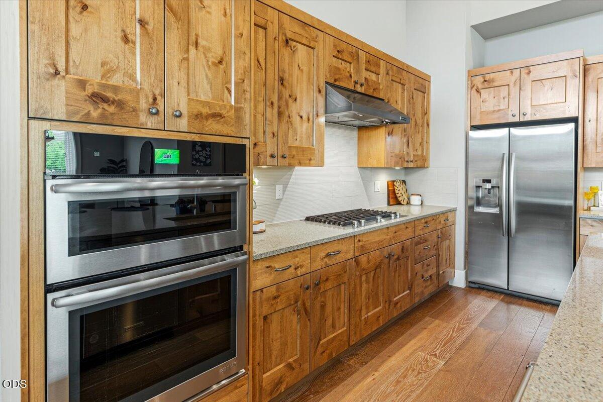 61333 Kindle Rock Loop Bend, OR 97702 - Photo 21 of 53 a kitchen with stainless steel appliances granite countertop a stove a sink and a microwave