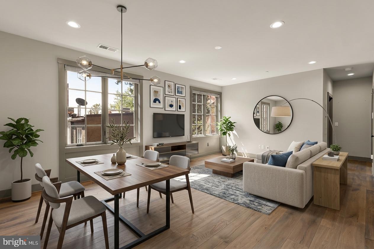 a living room with furniture a large window and a flat screen tv