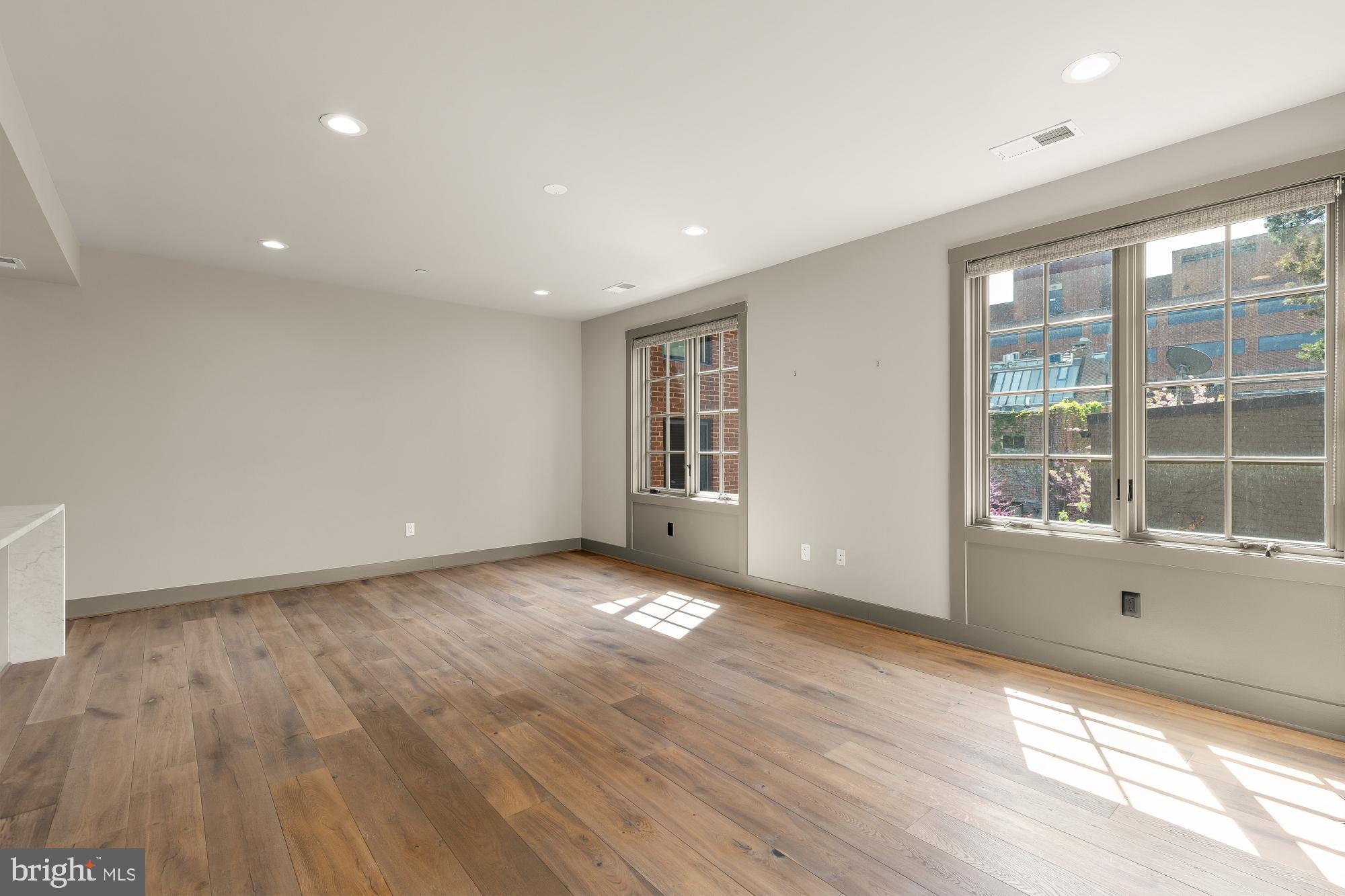 3220 Grace Street Northwest, Unit 5 Washington, DC 20007 - Photo 13 of 31 a view of empty room with wooden floor and fan