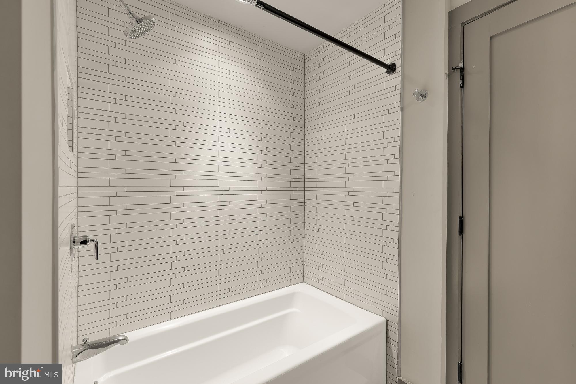 3220 Grace Street Northwest, Unit 5 Washington, DC 20007 - Photo 19 of 31 a bathroom with a white bathtub and shower