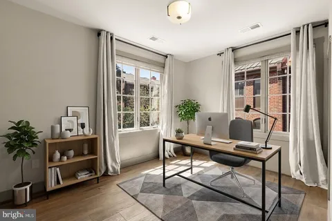 a workspace with furniture and a potted plant