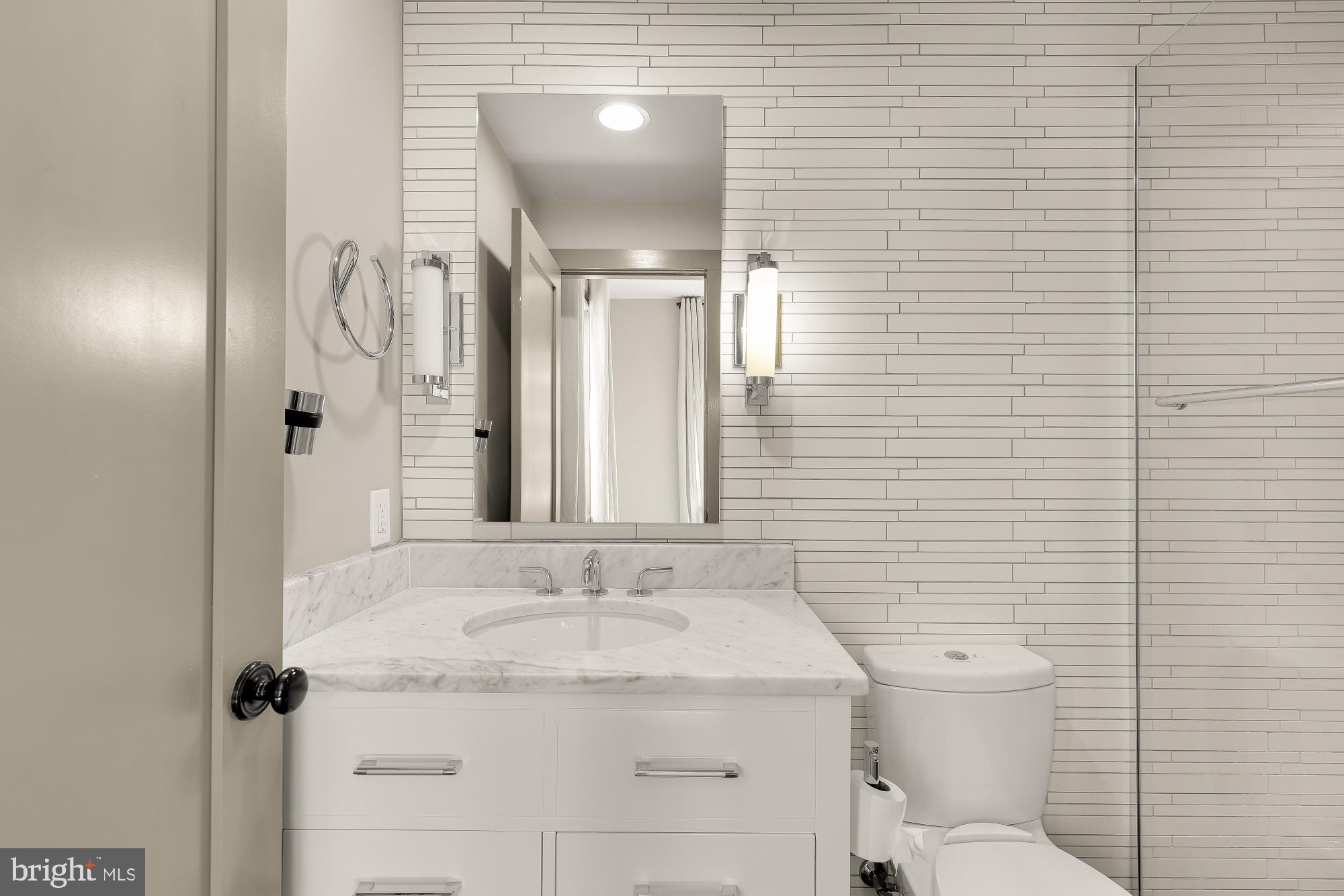 3220 Grace Street Northwest, Unit 5 Washington, DC 20007 - Photo 25 of 31 a bathroom with a granite countertop sink toilet and shower