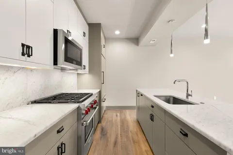 a kitchen that has a sink and a stove