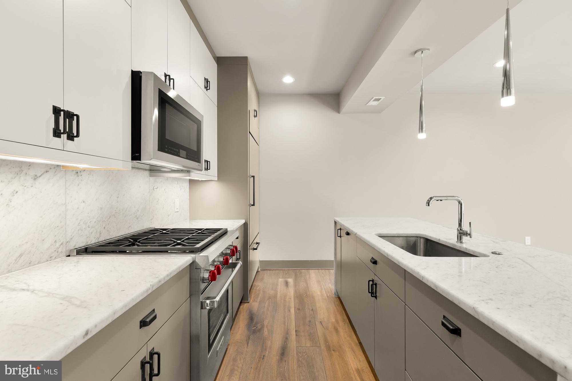 3220 Grace Street Northwest, Unit 5 Washington, DC 20007 - Photo 5 of 31 a kitchen that has a sink and a stove