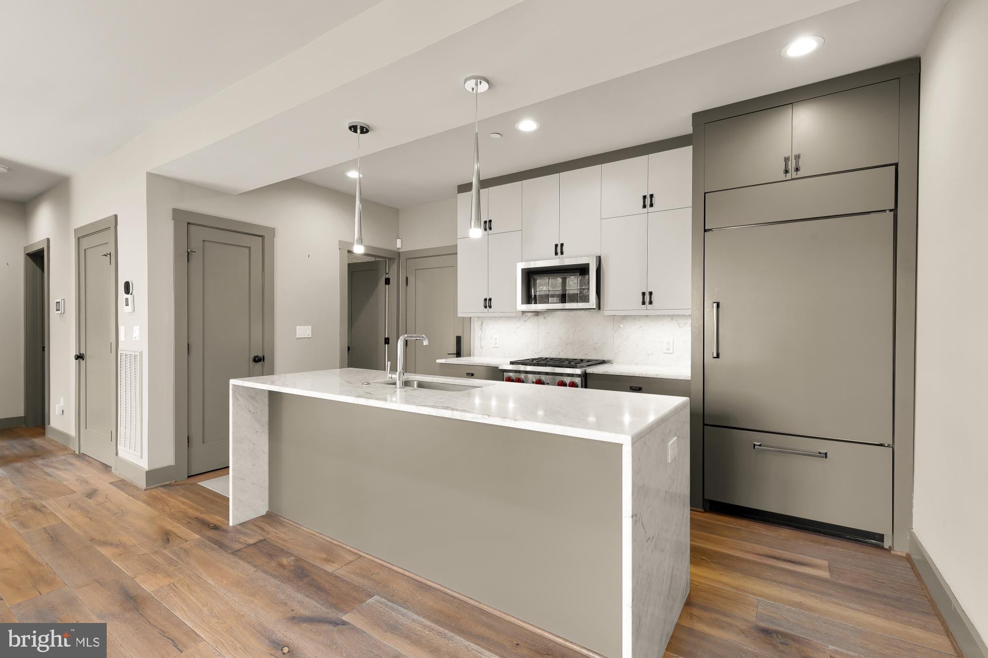 3220 Grace Street Northwest, Unit 5 Washington, DC 20007 - Photo 6 of 31 a kitchen with stainless steel appliances granite countertop a refrigerator sink and microwave