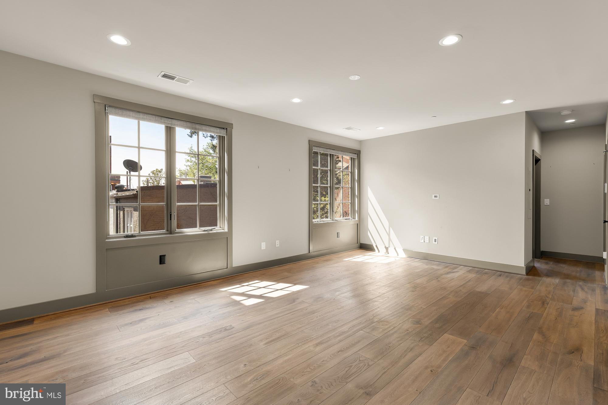 3220 Grace Street Northwest, Unit 5 Washington, DC 20007 - Photo 7 of 31 a view of empty room with wooden floor and fan