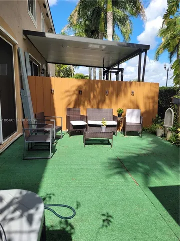 a backyard of a house with outdoor seating