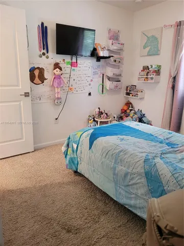 a bedroom with a bed and flat screen tv