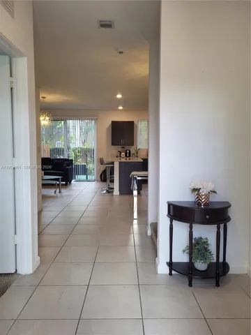 a view of kitchen with furniture and a refrigerator