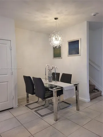 a view of a dining room with furniture and chandelier