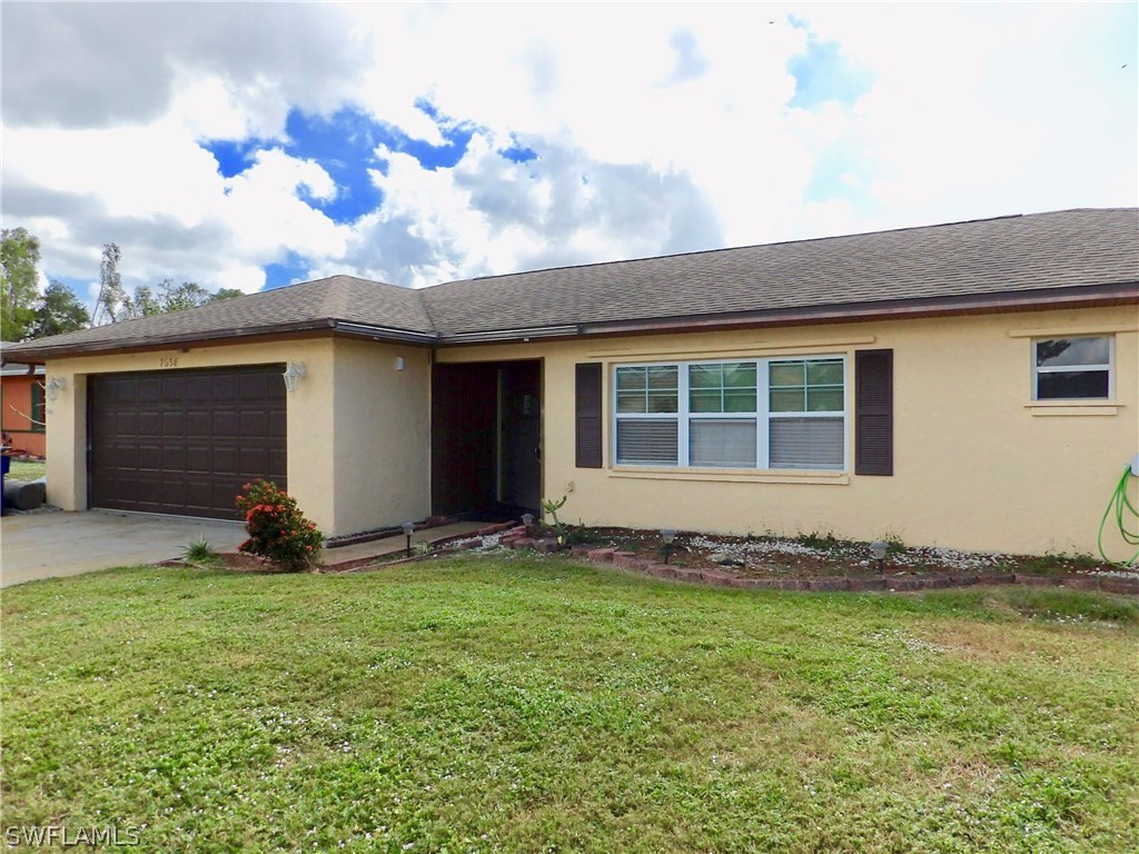 7658 Laurel Valley Road Fort Myers, FL 33967 - Photo 1 of 14 a front view of a house with a yard