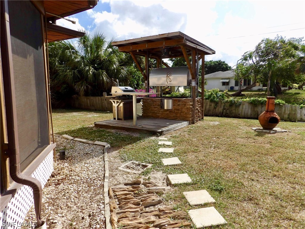 7658 Laurel Valley Road Fort Myers, FL 33967 - Photo 2 of 14 a view of a patio with table and chairs potted plants with wooden floor
