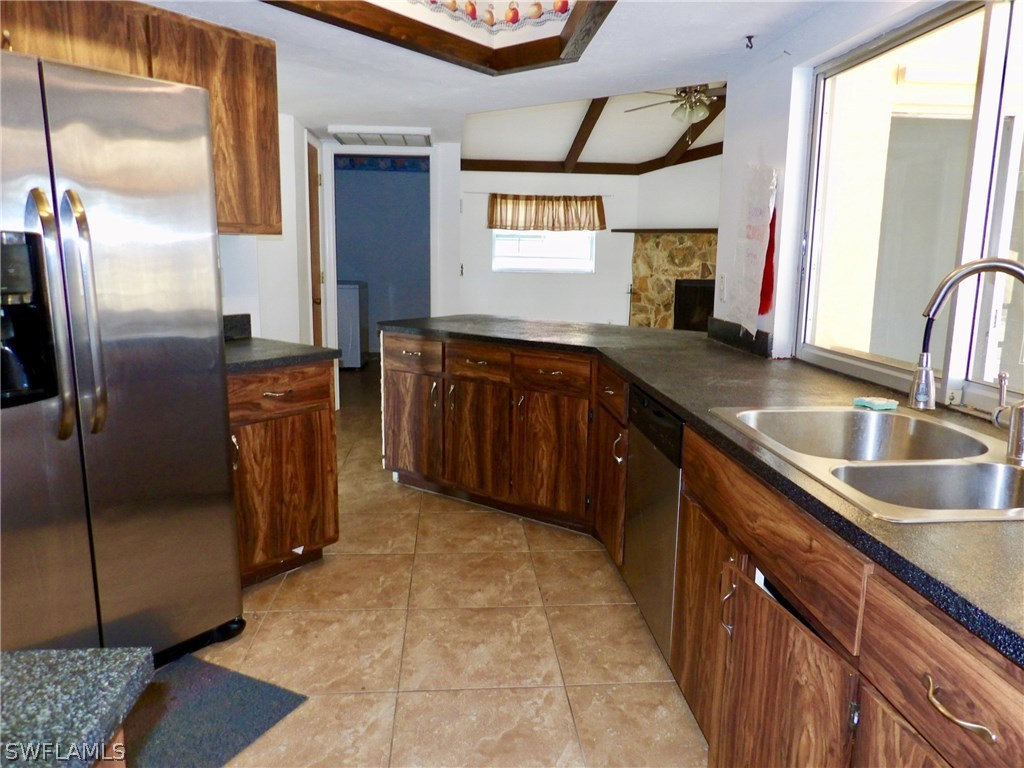 7658 Laurel Valley Road Fort Myers, FL 33967 - Photo 5 of 14 a kitchen with stainless steel appliances granite countertop a sink stove and refrigerator