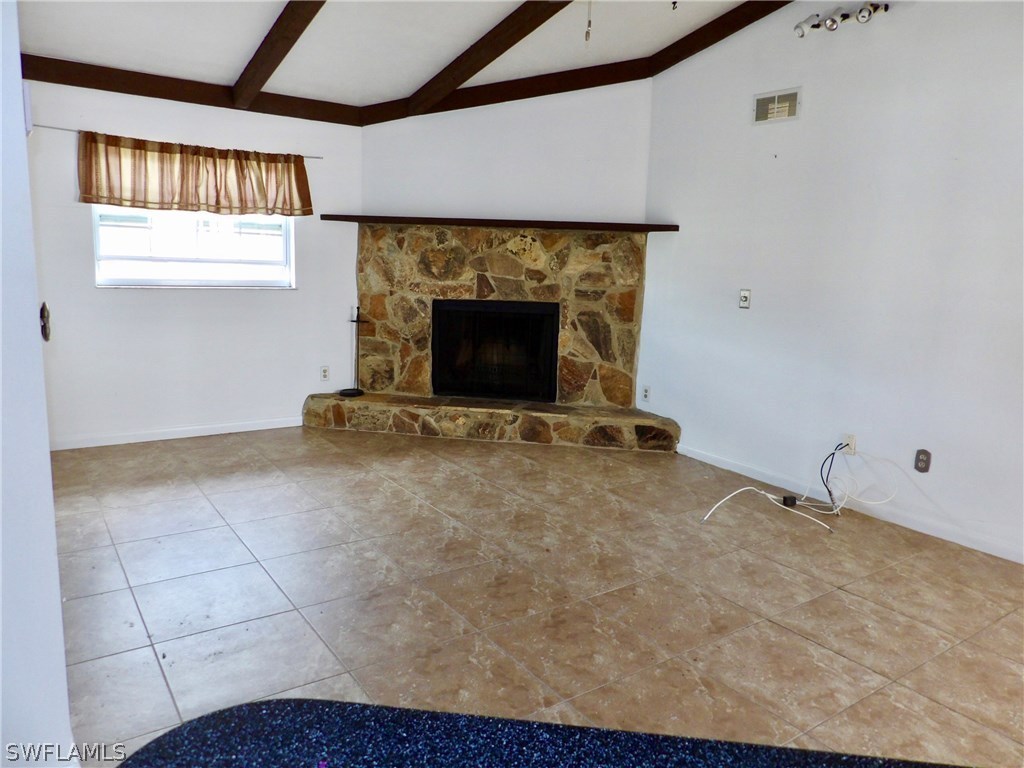 7658 Laurel Valley Road Fort Myers, FL 33967 - Photo 6 of 14 a view of an empty room with a fireplace