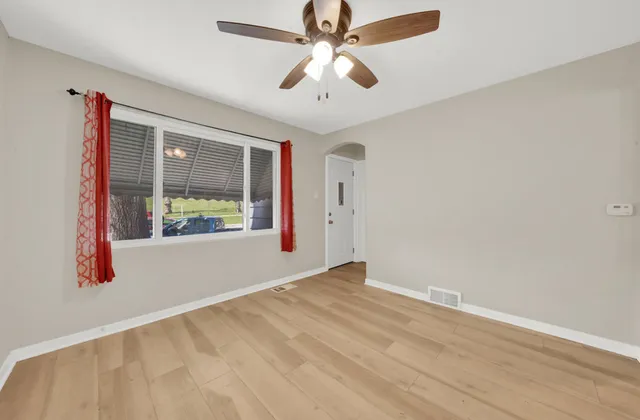 wooden floor in an empty room with a window