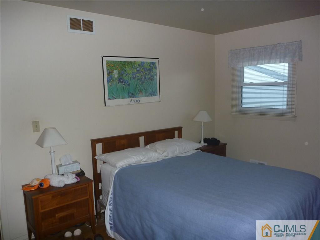 21 Mercer Road Old Bridge, NJ 08857 - Photo 22 of 25 a bedroom with a bed and a lamp on dresser