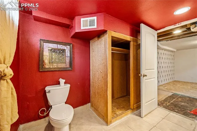 a bathroom with a toilet sink and shower