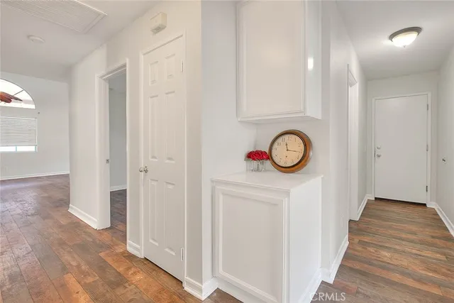a view of a hallway with wooden floor