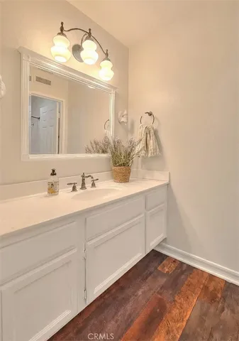 a bathroom with a sink vanity and mirror
