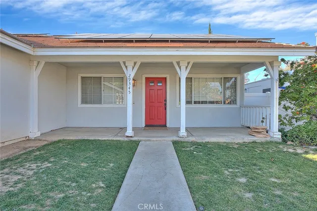 front view of the house with a yard