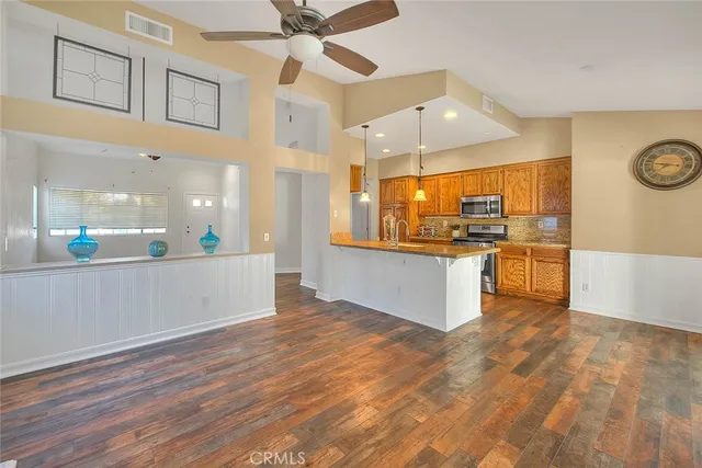 a view of a kitchen with a stove wooden floor and a kitchen space