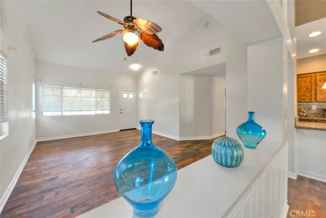 a view of a room with wooden floor and chandelier