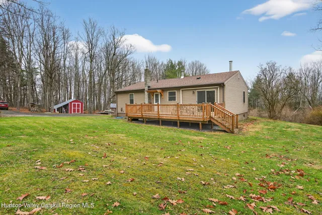 a view of a house with a yard porch and sitting area