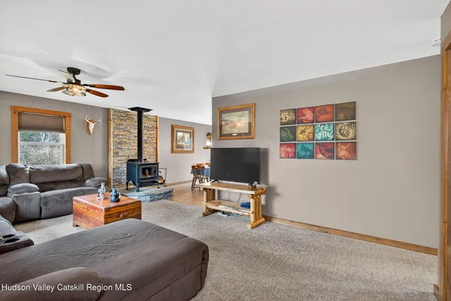 a living room with furniture gym equipment and a flat screen tv
