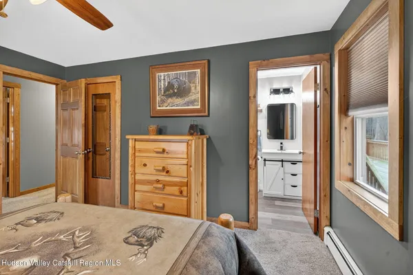 a bedroom with a bed and a dresser