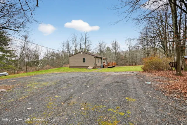 a view of a house with a yard and sitting area