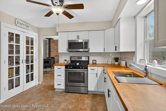 a kitchen with stainless steel appliances granite countertop a stove sink and microwave